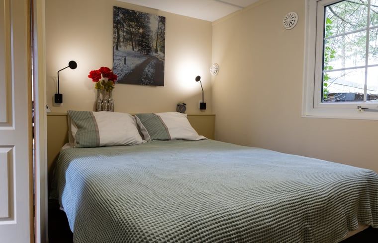 Cozy bedroom in Holiday Home in Emst, Gelderland, with large window.