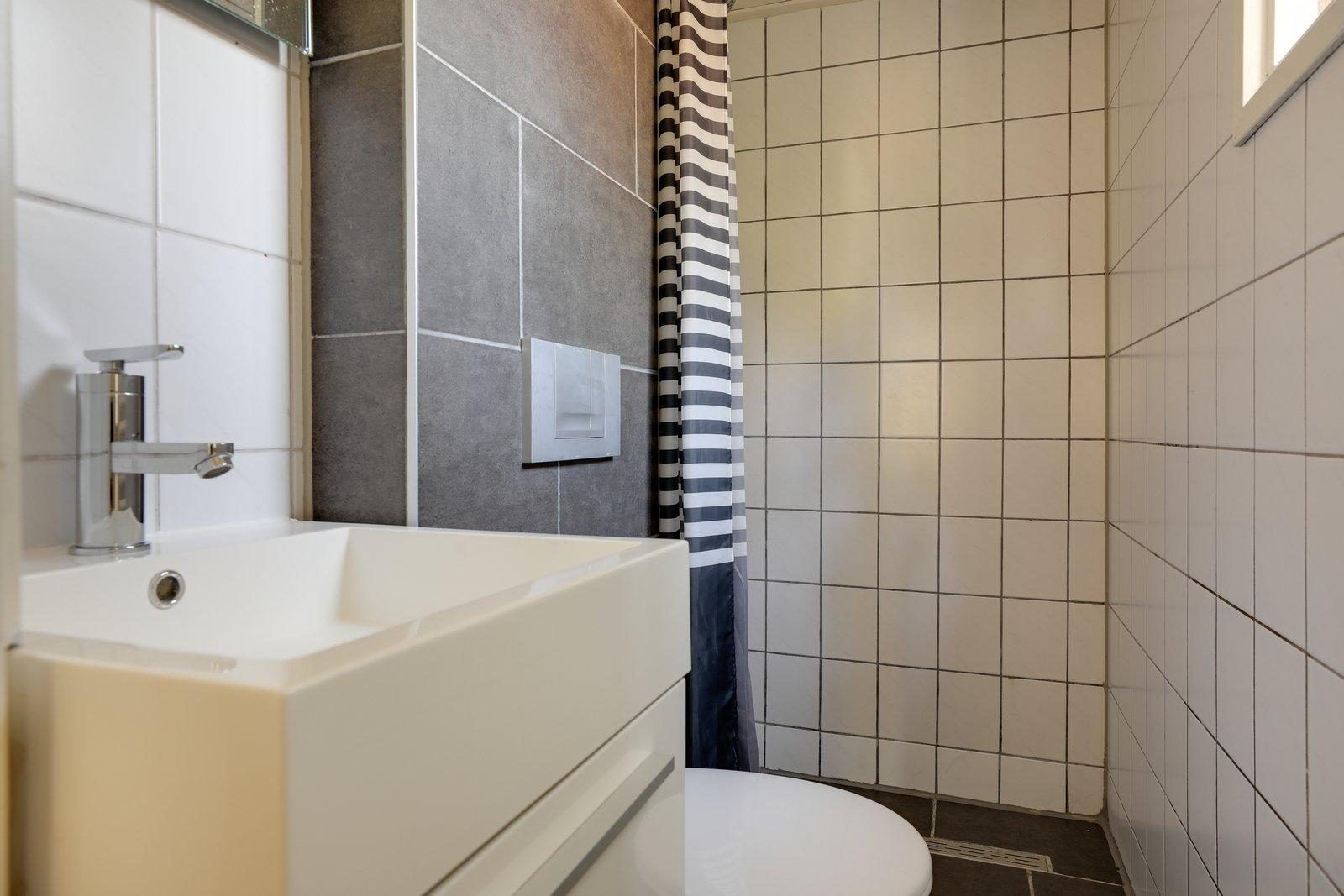 Modernes Badezimmer mit Dusche in der Tiny Lodge in Harderwijk, Veluwe, Gelderland fuer einen entspannten Aufenthalt.
