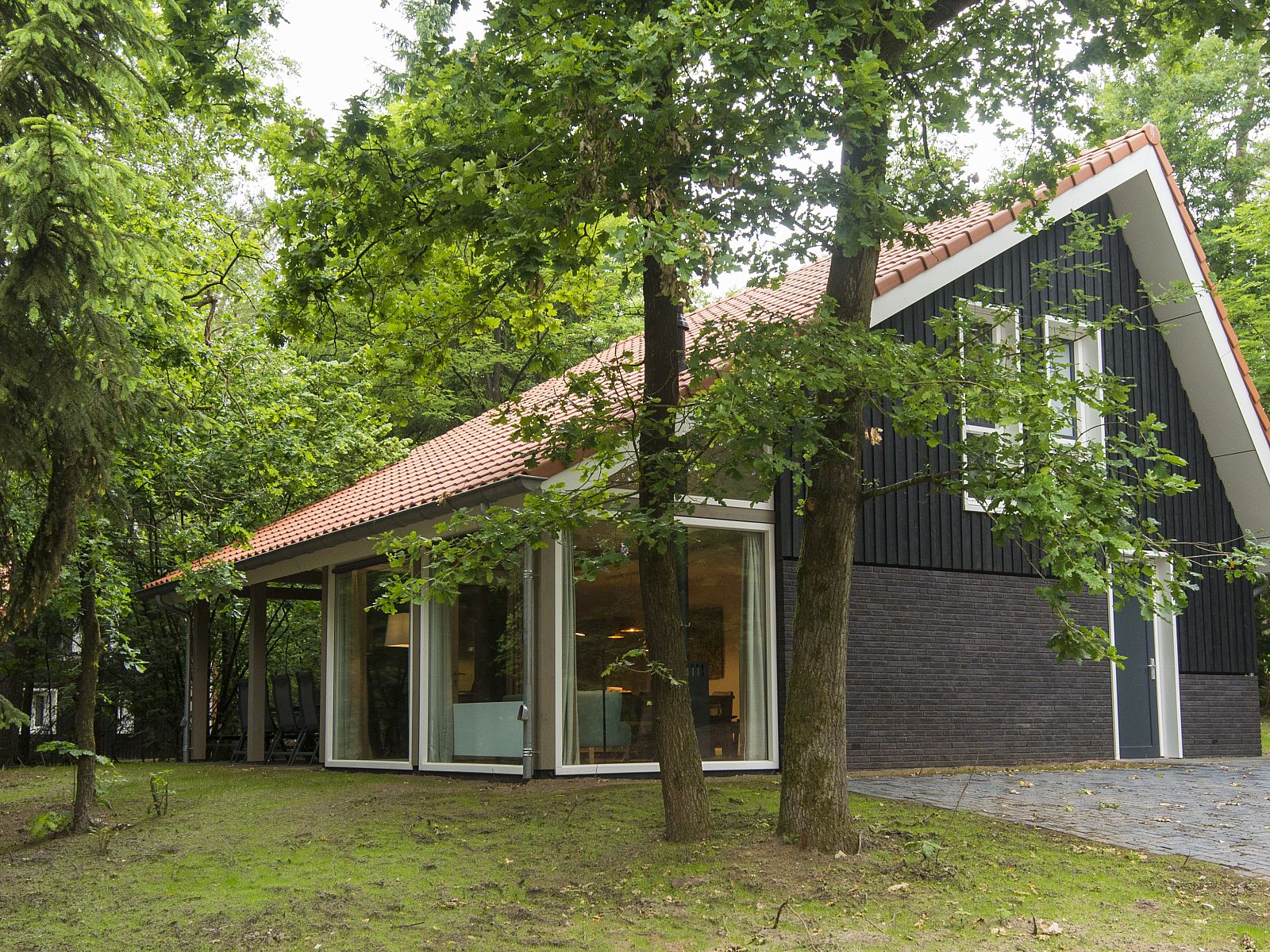 Dining room in Miggelenberg bungalow, Hoenderloo, Veluwe, Gelderland, with large wooden table.
