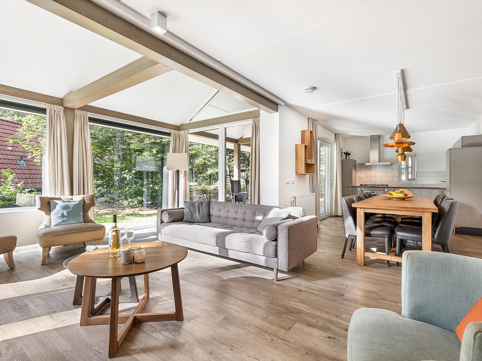 Outdoor dining with wine on terrace of Miggelenberg bungalow, Hoenderloo, Veluwe, Gelderland.