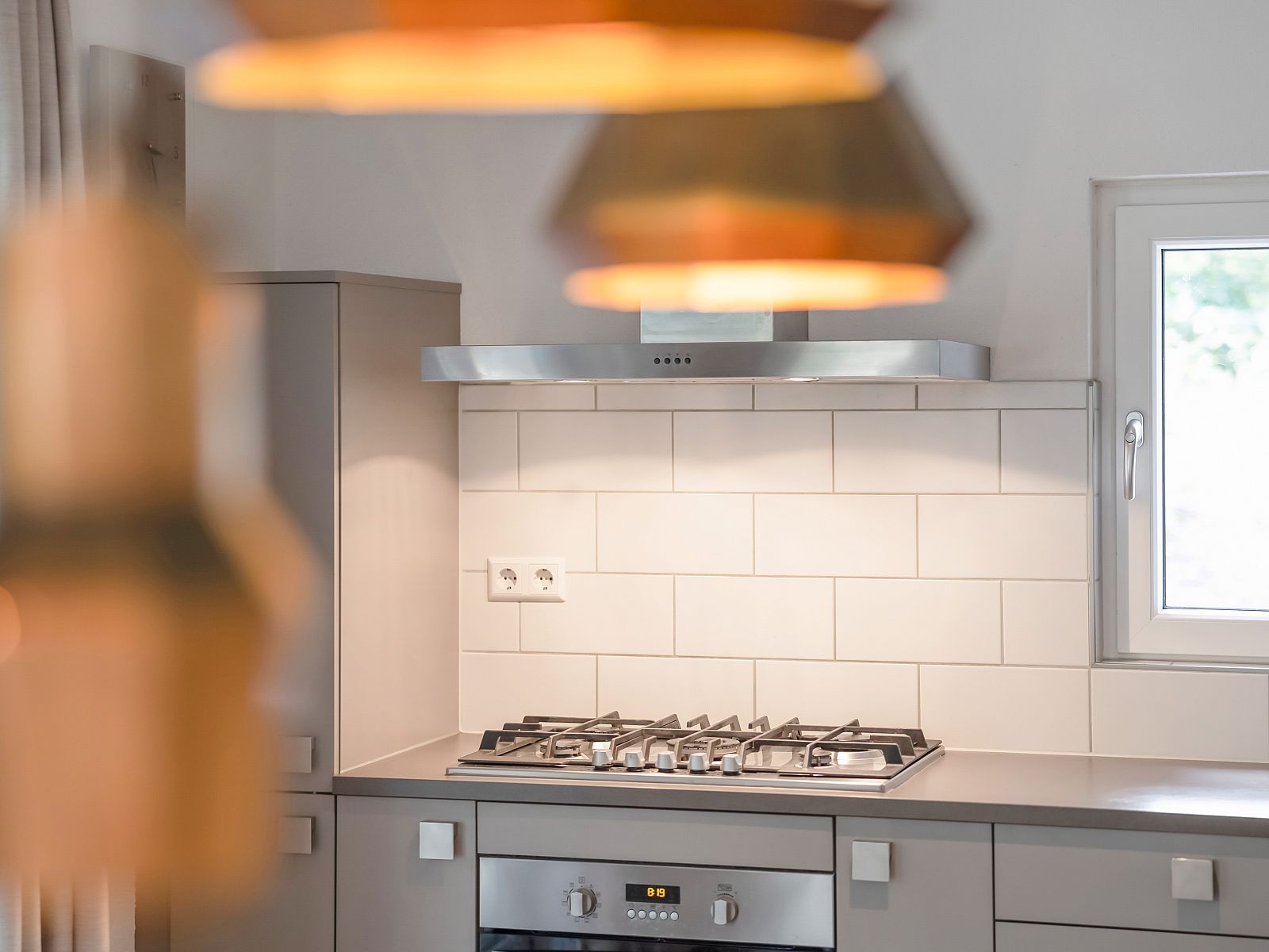 Modern bedroom in Miggelenberg bungalow, Hoenderloo, Veluwe, Gelderland with large windows.