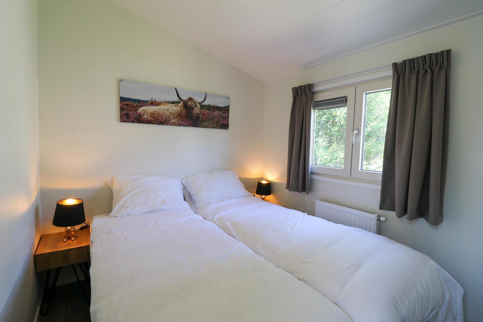Comfortable bedroom in Holiday home Heidehoeve comfort in Hoenderloo, overlooking the Veluwe, Gelderland.