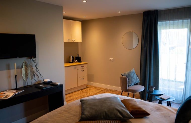 Gemuetliche Sitzecke im Ferienhaus in Hoenderloo, Veluwe, mit moderner Ausstattung und gemuetlicher Einrichtung.