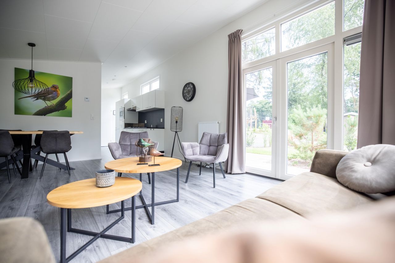 Bright and spacious living room in the detached house in Hoenderloo, Veluwe, with large windows.