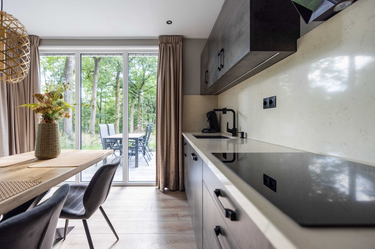 Kche mit Blick auf die Natur in einem freistehenden Haus in Hoenderloo, Veluwe, Gelderland. Ferienhaus mit moderner Kche.