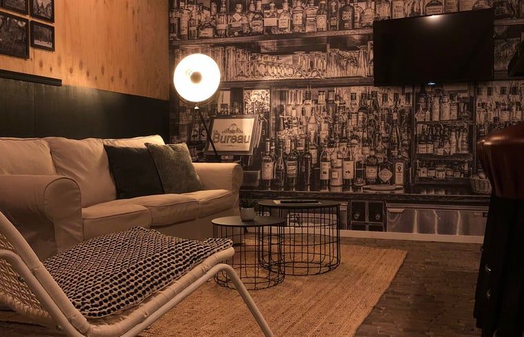 Attractive living room in Holiday home in 't Harde, Veluwe, with unique wall decoration.