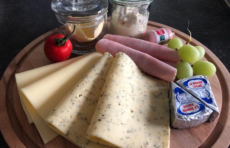 Breakfast options at Holiday Home in 't Harde, Veluwe, with cheese, ham and fresh fruit.