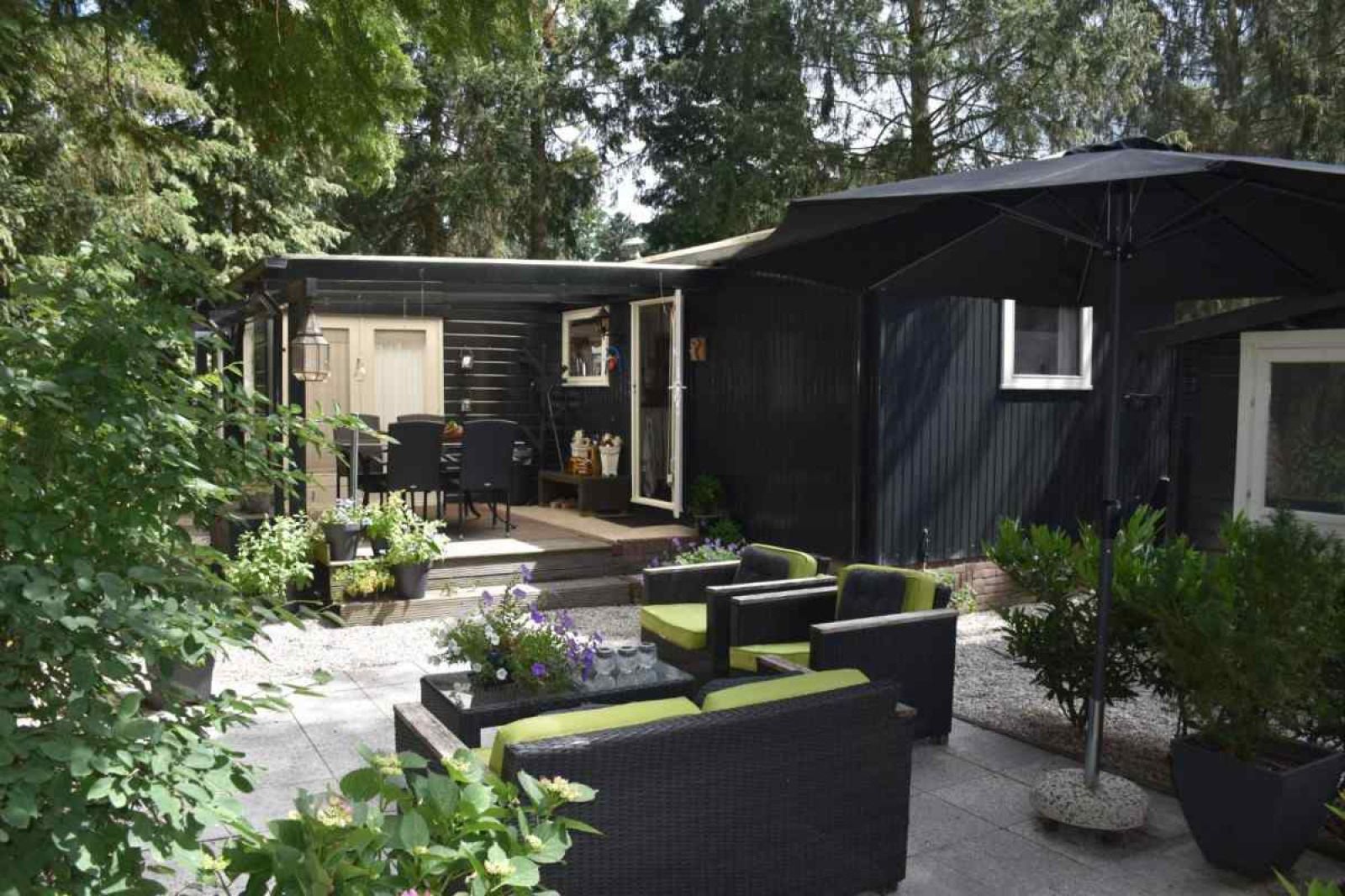 Outdoor terrace with seating areas at DG256 vacation home in Putten, Veluwe, Gelderland.