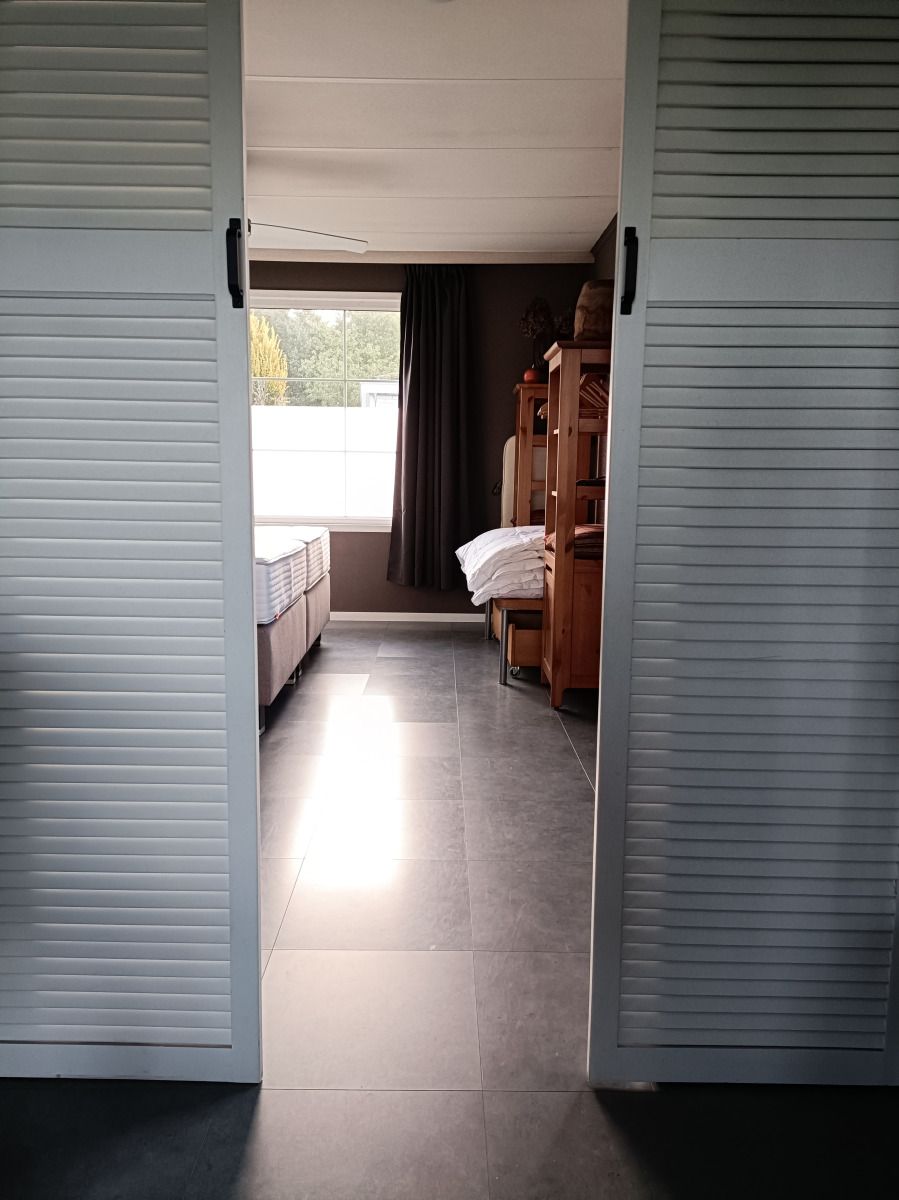 Spacious bedroom in DG1546 vacation home Putten Veluwe with lots of natural light.