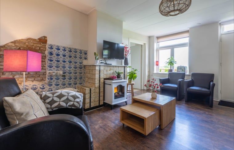 Cozy sitting area in Holiday Home in Wezep Oldebroek, Veluwe, Gelderland with fireplace.