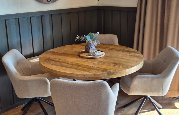 Ronde eettafel met comfortabele stoelen in Vakantiehuis in Voorthuizen Veluwe.