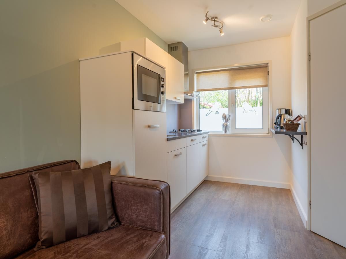 Kueche und Sitzecke im modern eingerichteten Ferienhaus Pimpelmees in Hulshorst, Veluwe.