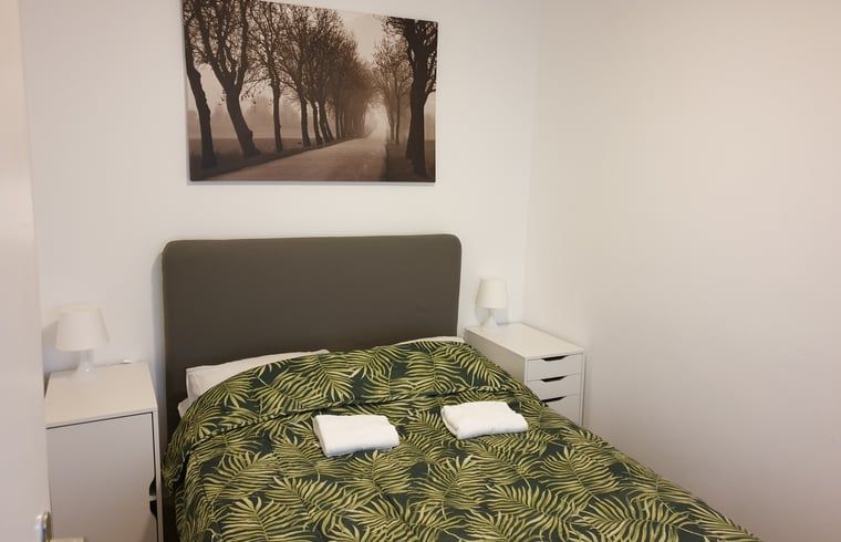 Knusse slaapkamer met tweepersoonsbed in Vakantiehuis in Otterlo, Veluwe, biedt comfort en stijl.