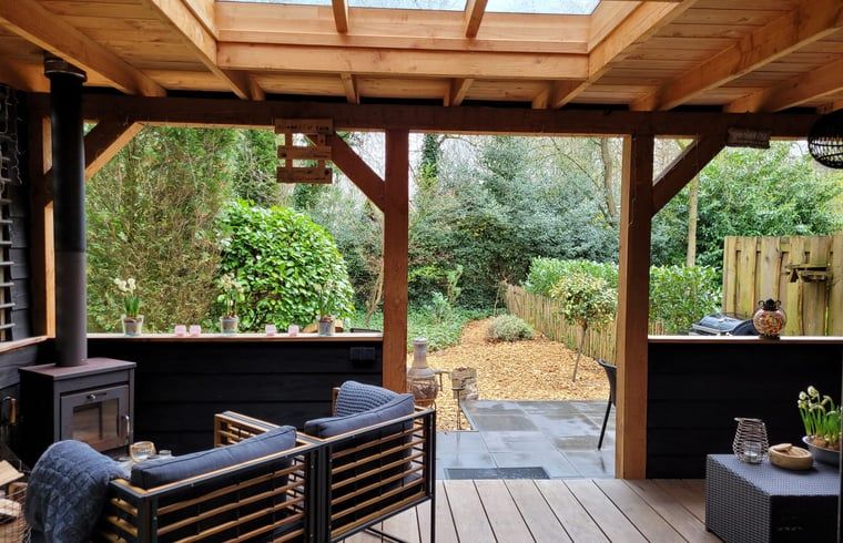 Enjoy the peace and quiet on the veranda of Holiday Home in Epe, Veluwe, Gelderland, overlooking the green garden and surrounding nature.