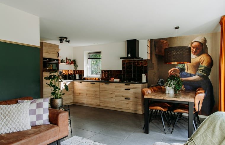 Stylish kitchen in Holiday Home in Nunspeet, Veluwe, with modern appliances and cozy dining area.