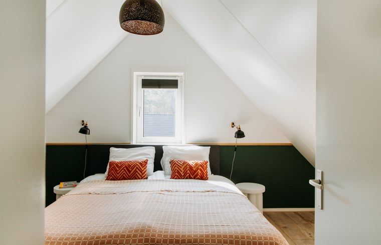 Bright bedroom in Holiday Home in Nunspeet, Veluwe, with a comfortable double bed and modern furnishings.