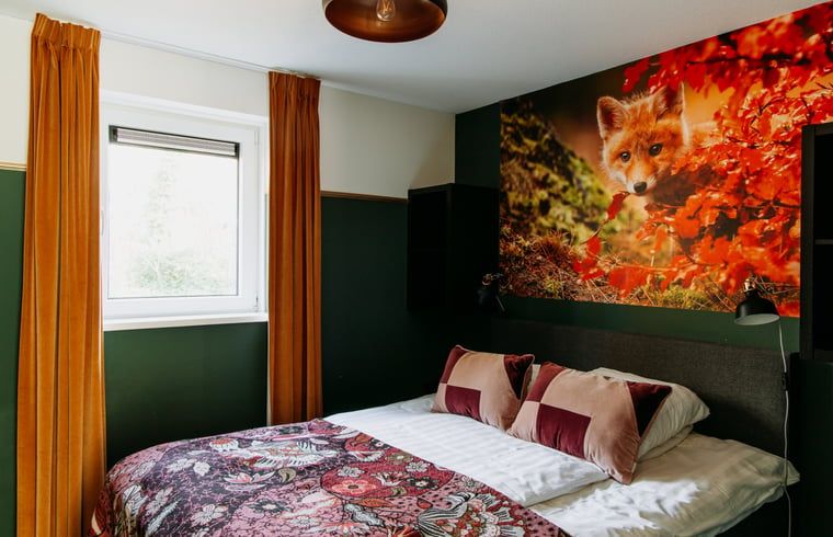 Attractive bedroom in Holiday Home in Nunspeet, Veluwe, with colorful accents and a large window.