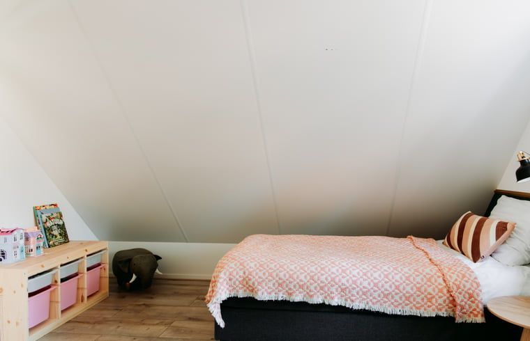 Cozy children's room in Cottage in Nunspeet, Veluwe, with playful furnishings and comfortable beds.