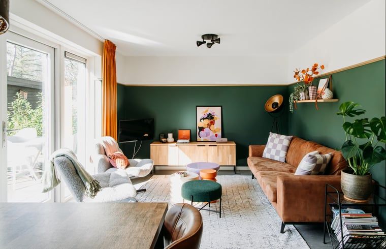 Bright living room in Cottage in Nunspeet, Veluwe, with modern furnishings and access to the terrace.