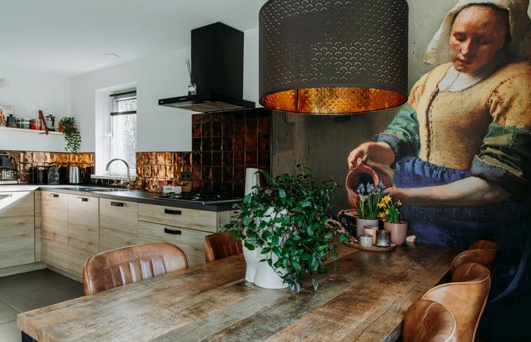 Spacious kitchen and dining room in Holiday cottage in Nunspeet, Veluwe, with modern appliances and cozy atmosphere.