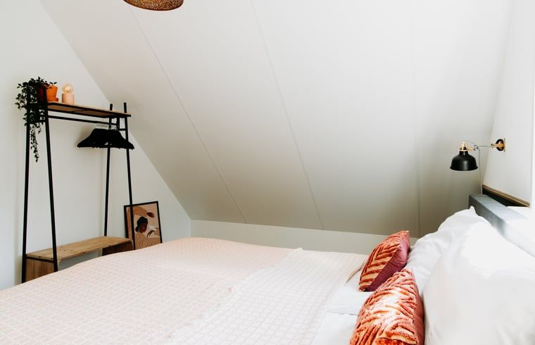 Bright bedroom in Cottage in Nunspeet, Veluwe, with modern furnishings and comfortable beds.