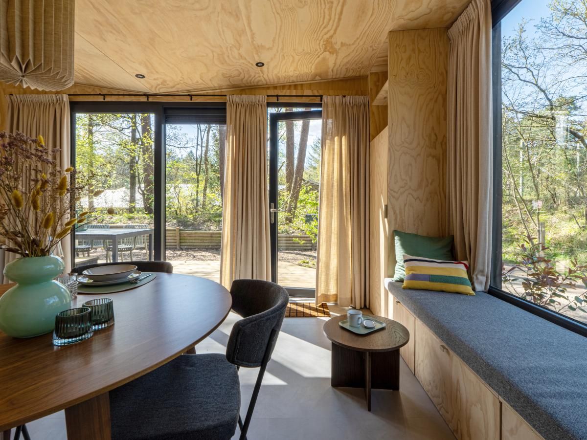 Binnenruimte van vakantiehuis Mos in Nunspeet, Veluwe, met uitzicht op terras en natuur. Ideale plek voor ontspanning in Gelderland.