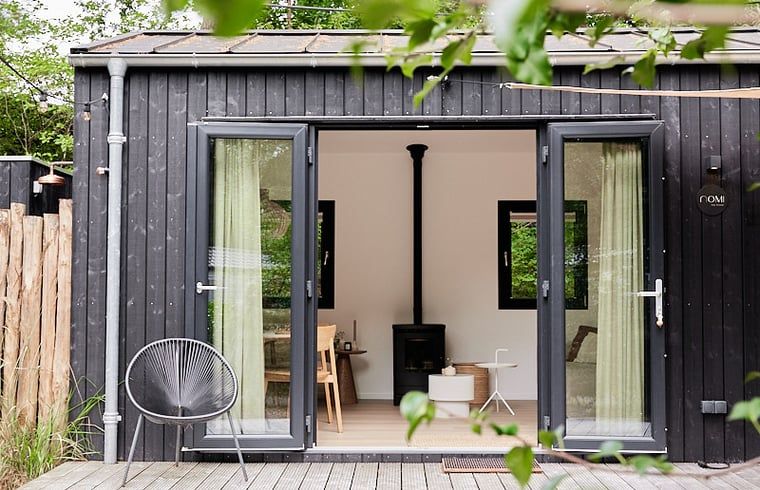 Enjoy the terrace at Cottage in Nunspeet, Veluwe, Gelderland, with an inviting dining table and green surroundings.