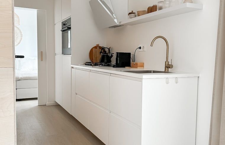 Cozy reading corner in Cottage in Nunspeet, Veluwe, Gelderland with comfortable chair and modern decorations.