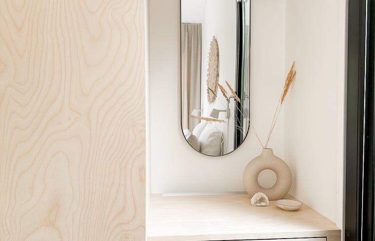 Relaxation in the bedroom of Cottage in Nunspeet, Veluwe, Gelderland, overlooking the green surroundings.