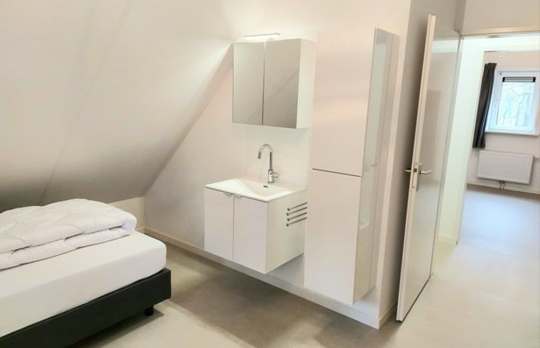 Practical sink in attic room of cottage in Nunspeet, Veluwe, for added convenience in Gelderland.