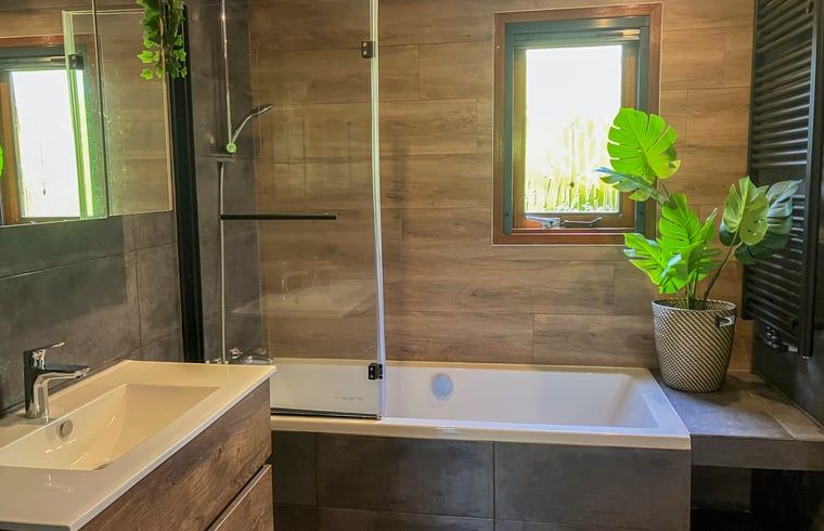 Stylish bathroom in Cottage in Lunteren, Veluwe, with bathtub and natural elements.