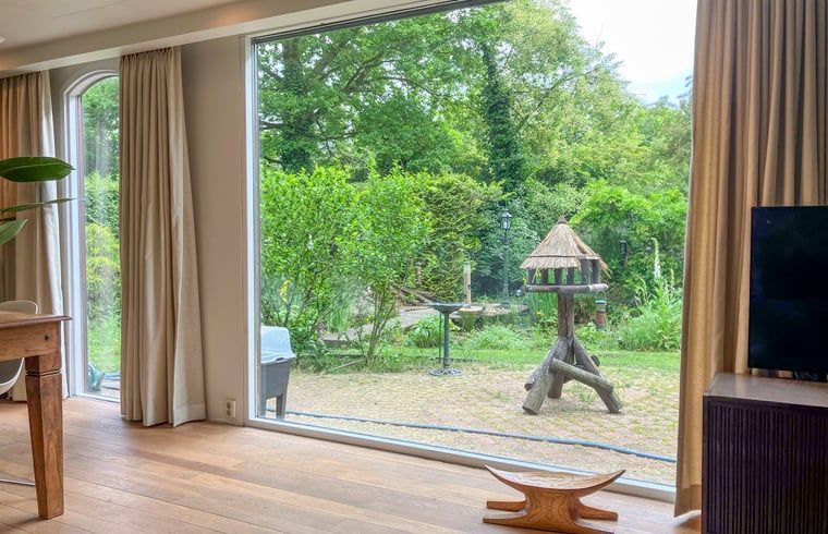 View from the living room of Cottage in Lunteren, Veluwe, of the garden.