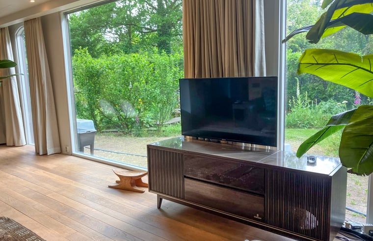 Living room in Cottage in Lunteren, Veluwe, with modern television and green view.