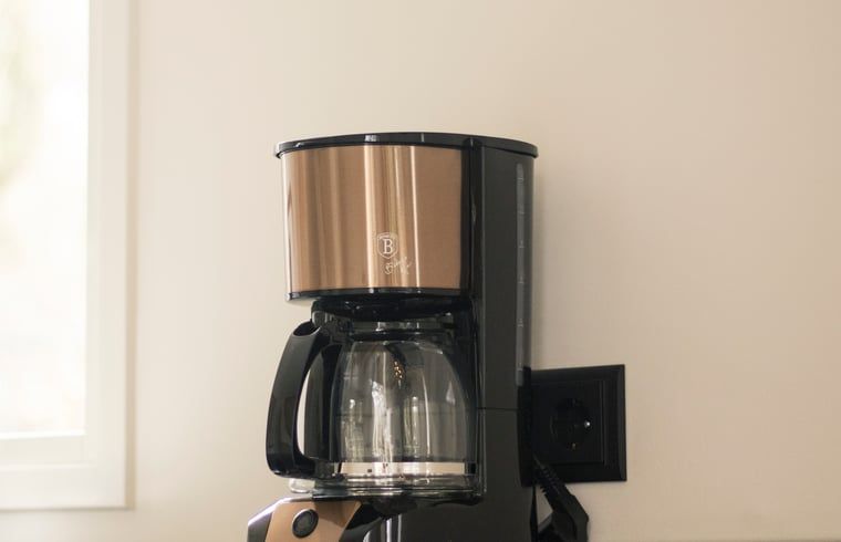 Vakantiehuisje in Uddel, Veluwe, met een knusse slaapkamer en houten balken.