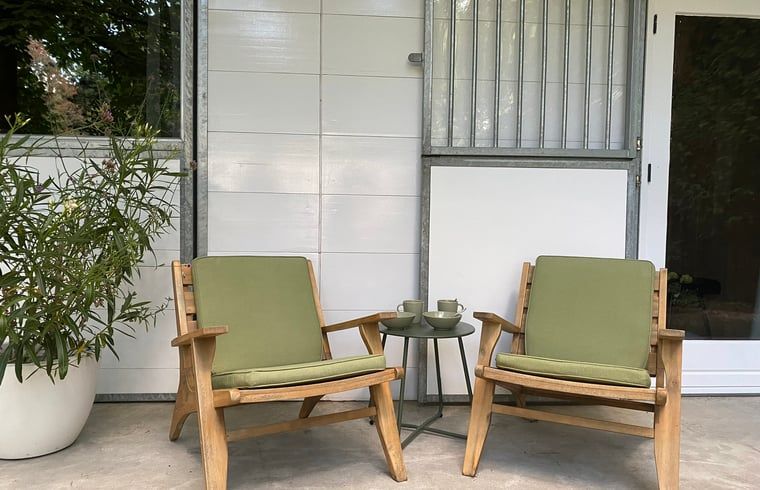 Comfortable chairs on the porch of Cottage in Hattem, Veluwe, Gelderland.