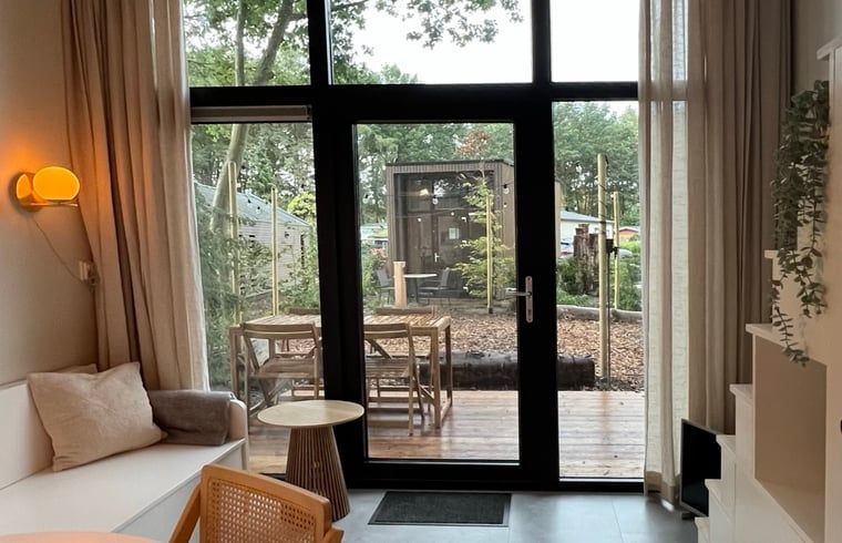 Cozy sitting area in Holiday Home in Lieren overlooking terrace.
