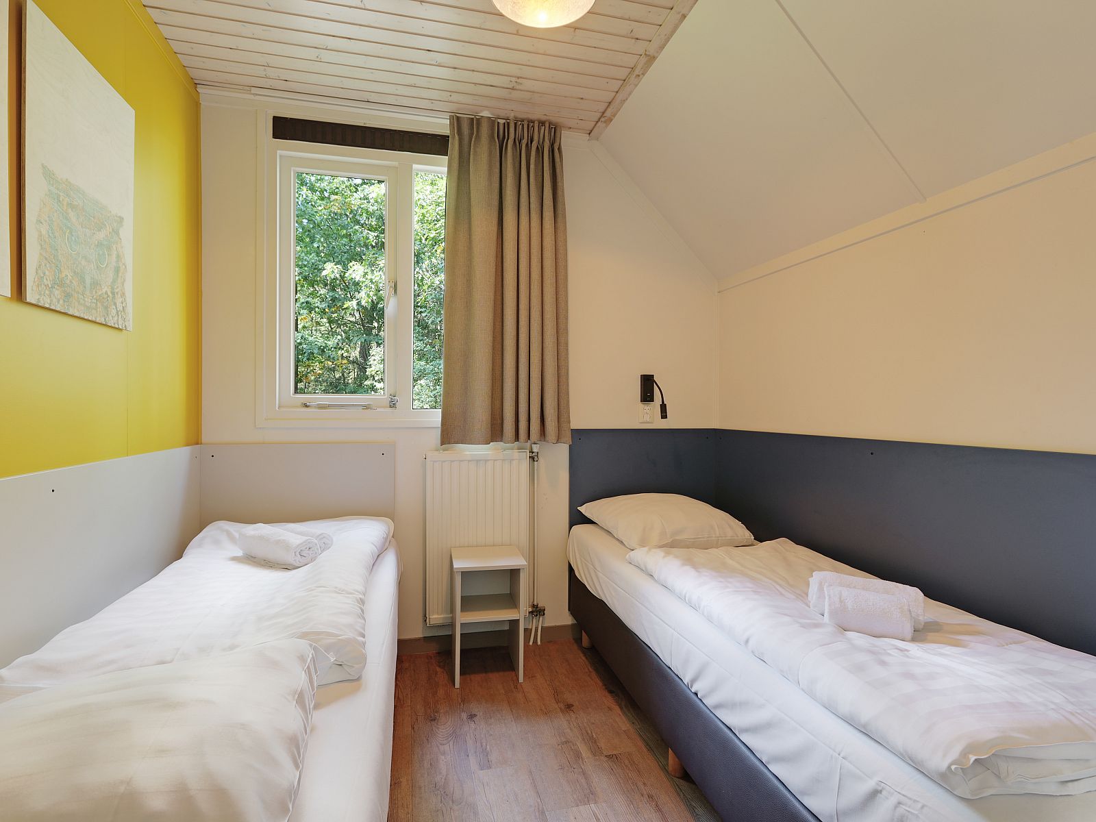 Terras met tuinmeubilair bij Rabbit Hill 8-persoons bungalow 8C in Nieuw Milligen, Veluwe, omgeven door natuur.