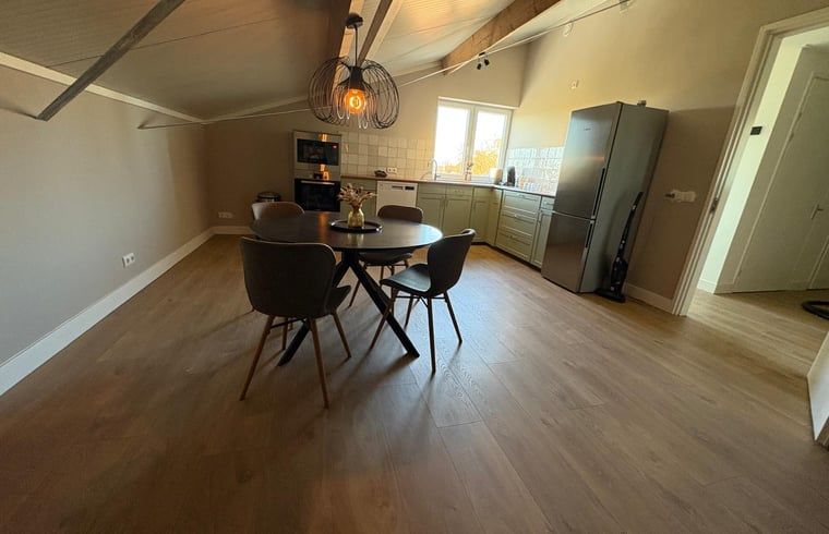 Cozy kitchen and dining area in Cottage in Schildwolde, Northeast Groningen, ideal for a relaxing stay.
