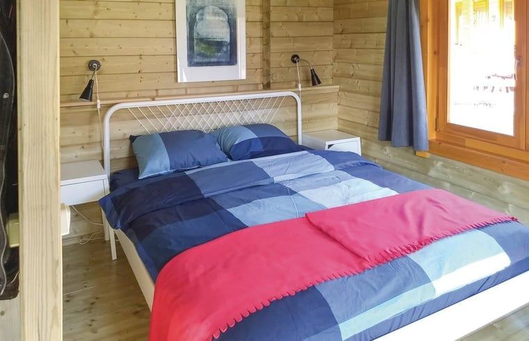 Comfortable bedroom in cottage in Zoutkamp overlooking the nature of Groningen.