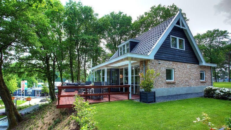Villa Vallonne 6, a charming vacation home in Belfeld, North Limburg, with spacious veranda and green surroundings.