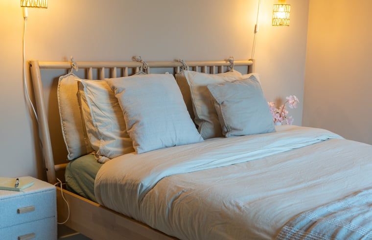 Cozy bedroom in Holiday Home in America, North Limburg, with rustic decor and warm lighting.