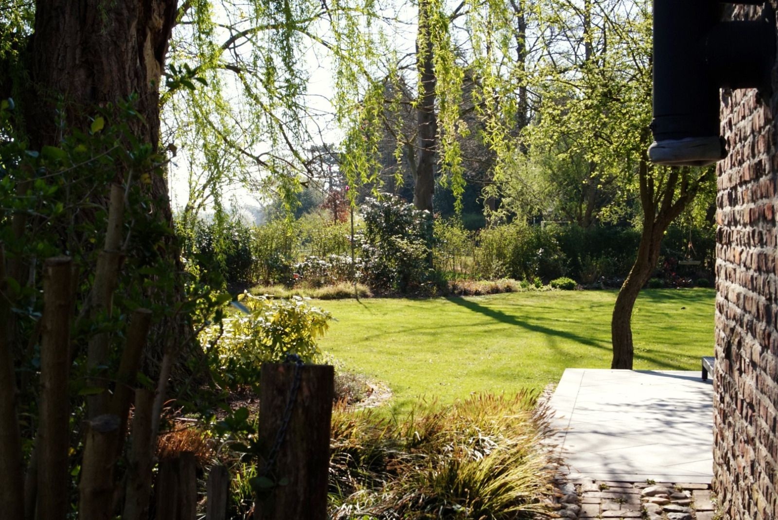 Enjoy peace and quiet on the terrace of vacation home L185 in Baarlo, North Limburg, surrounded by nature and historic stone walls.