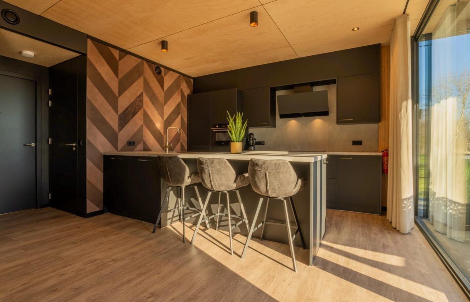 Modern kitchen in Bos Villa, a vacation home for 8 people in Maasbree, North Limburg. Stylish interior with lots of natural light.