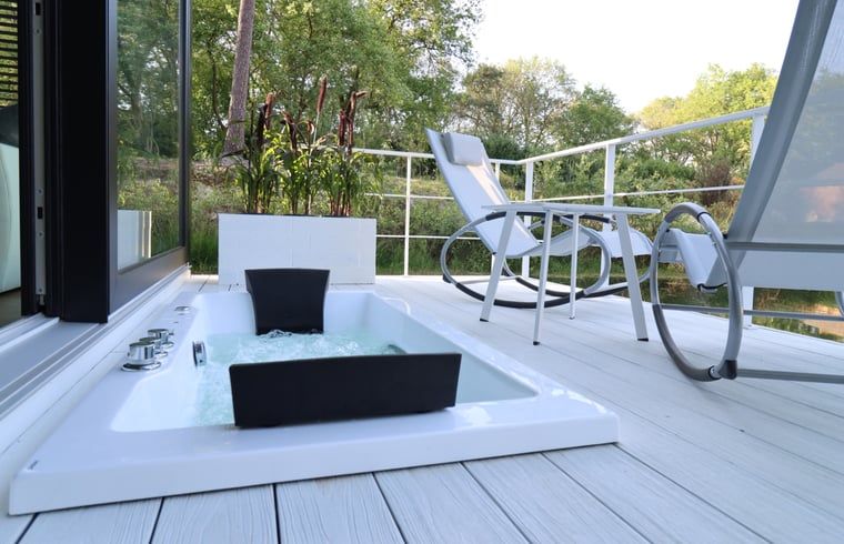 Ontspan op het terras van Vakantiehuis in Merselo, Noord Limburg, met een luxe bubbelbad en uitzicht op de groene natuur.