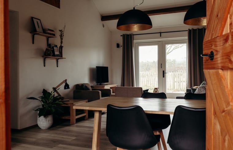 Woonkamer in Vakantiehuisje in Grashoek, Noord Limburg. Comfortabele zithoek met uitzicht op de tuin.