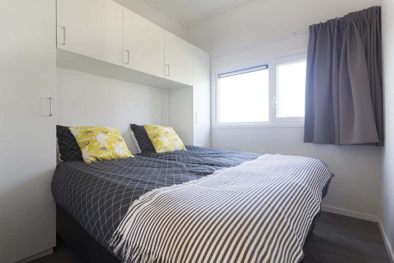 Comfortable bedroom in Module 6 persons vacation home Schin op Geul, South Limburg with modern decor and lots of light.