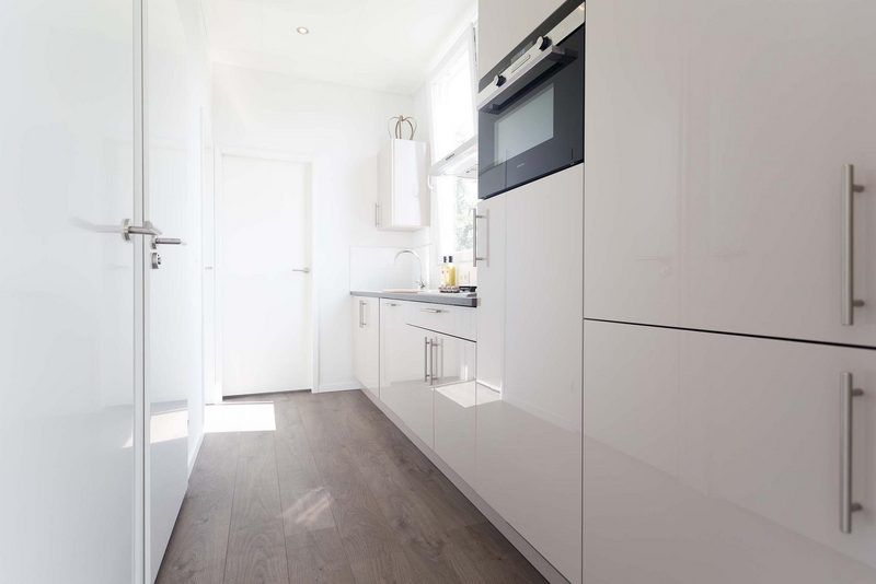 Sleek kitchen in Module 6 persons vacation home Schin op Geul, South Limburg with modern appliances and plenty of storage space.