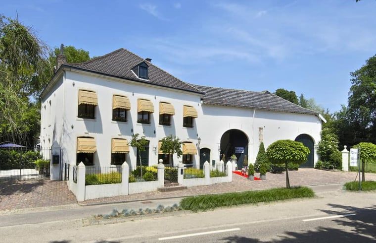 Exterior of Cottage in Valkenburg, vacation home in South Limburg, with classic facade and green surroundings.