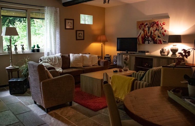 Cozy living room with comfortable sofas in Cottage in Valkenburg, vacation home in South Limburg.