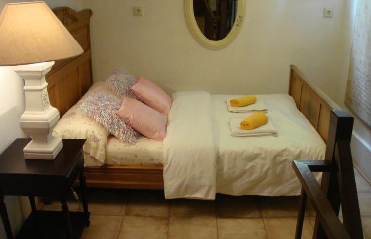 Small bedroom with double bed in Cottage in Valkenburg, vacation home in South Limburg.